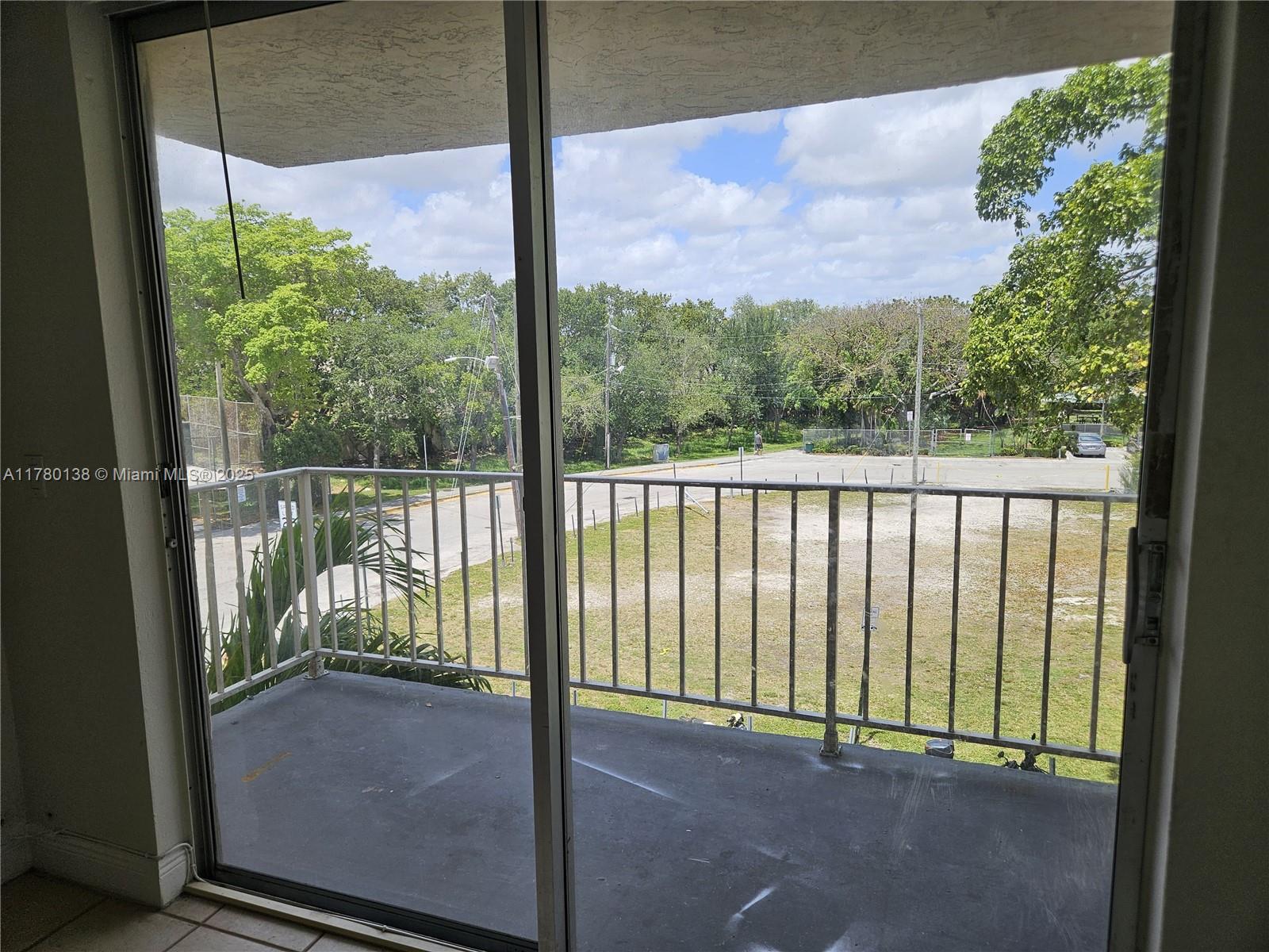 1805 Sans Souci Boulevard, Unit 302R North Miami, FL 33181 - Photo 23 of 33 a view of a glass door with a from a window