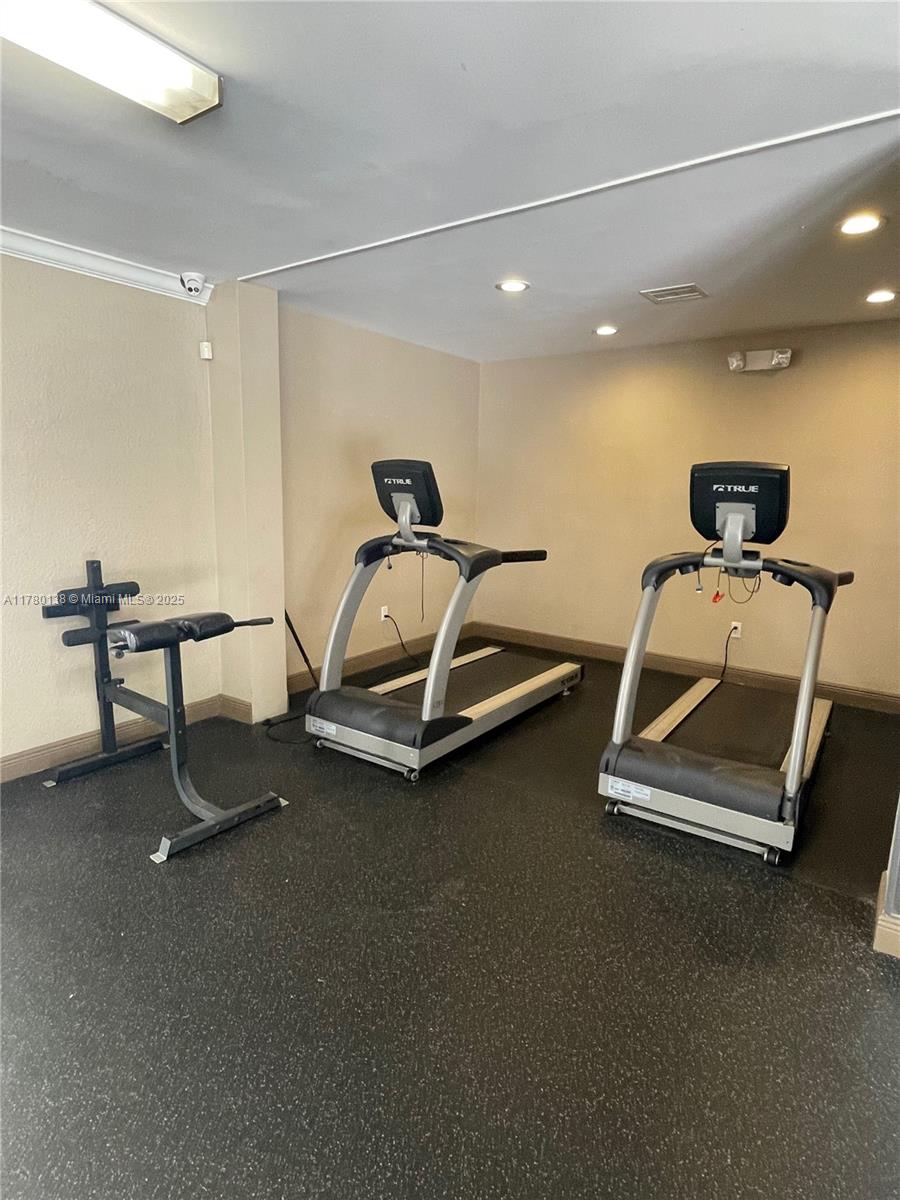 1805 Sans Souci Boulevard, Unit 302R North Miami, FL 33181 - Photo 30 of 33 a room with gym equipment
