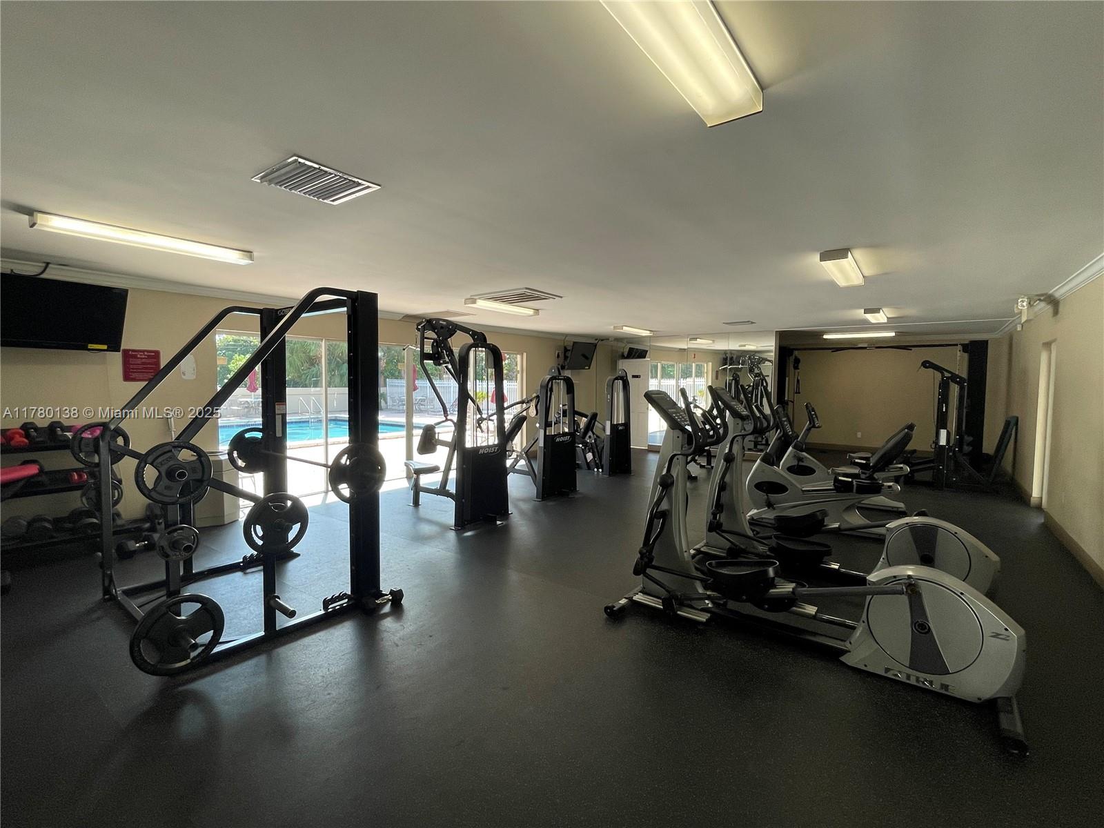 1805 Sans Souci Boulevard, Unit 302R North Miami, FL 33181 - Photo 31 of 33 a view of a room with gym equipment