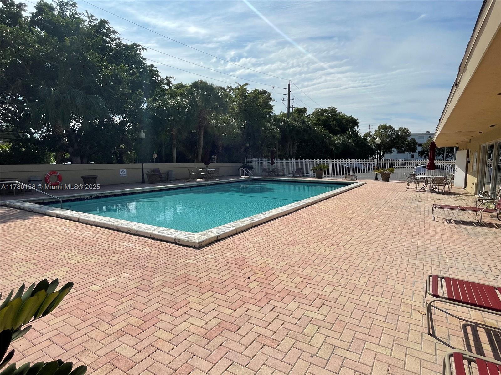 1805 Sans Souci Boulevard, Unit 302R North Miami, FL 33181 - Photo 33 of 33 a view of a swimming pool with a yard