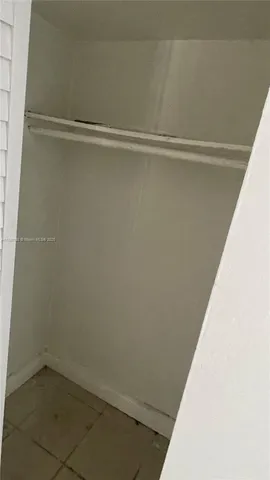 a white toilet sitting next to a shower