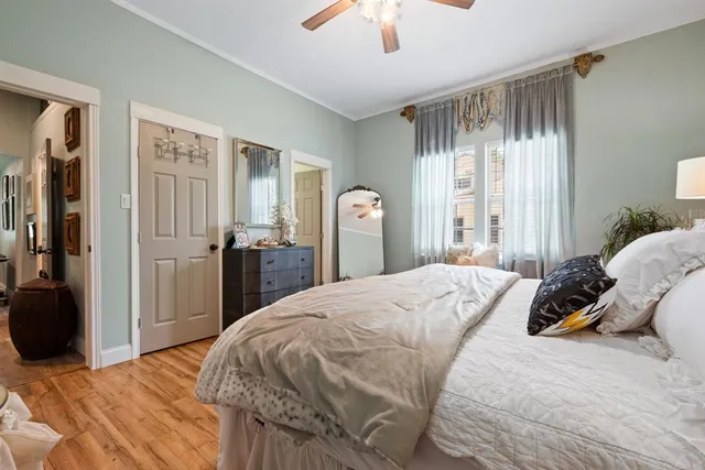 a bedroom with a bed and a chandelier