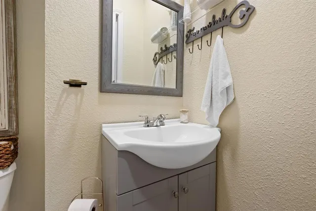 a bathroom with a sink a mirror and a shower