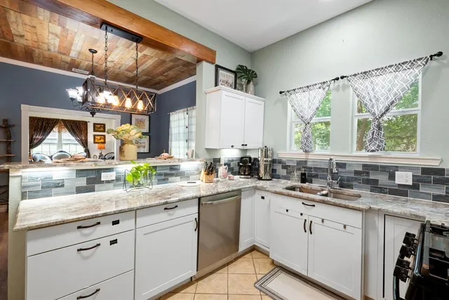 a kitchen with a sink window and cabinets