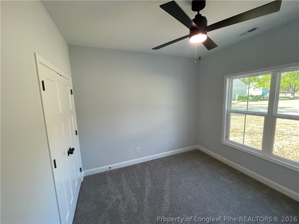 2677 Smith Mill Road Lumberton, NC 28358 - Photo 13 of 27 an empty room with windows and fan