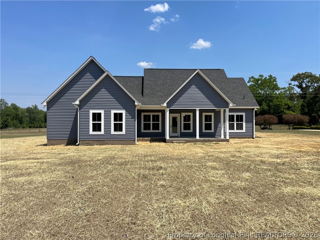 2677 Smith Mill Road Lumberton, NC 28358 - Photo 2 of 27 a front view of a house with a garden