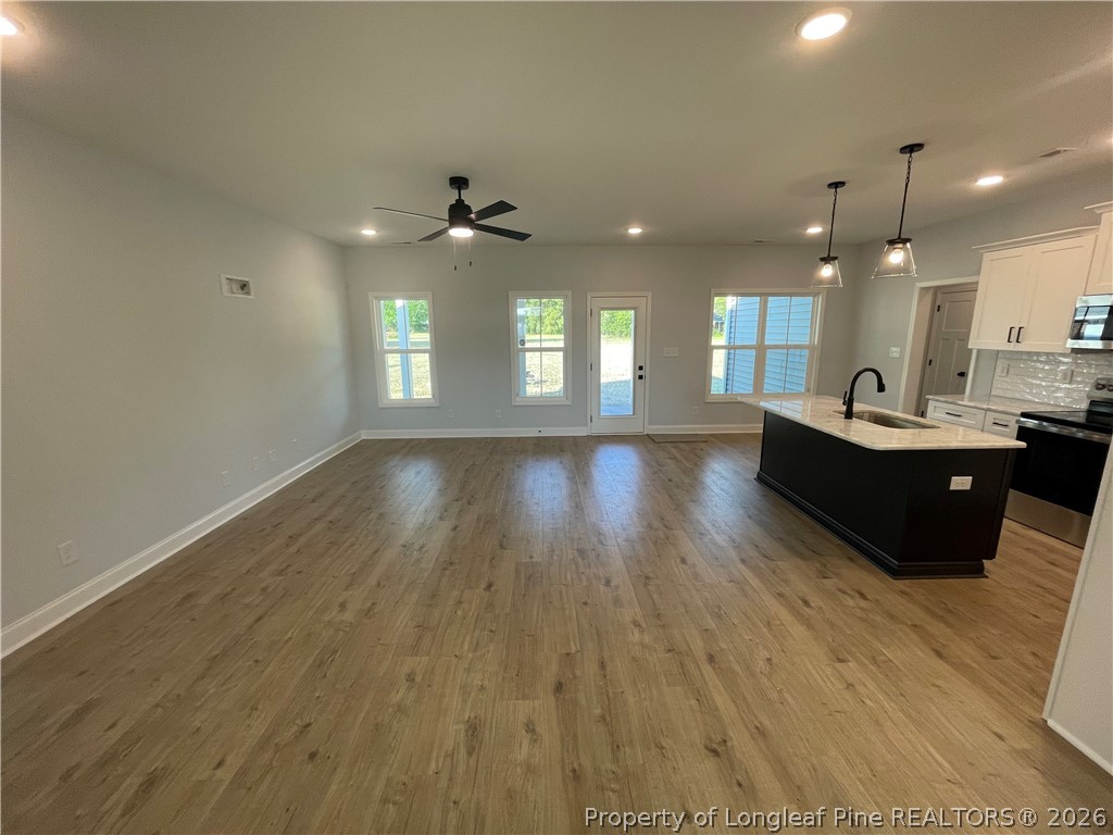 2677 Smith Mill Road Lumberton, NC 28358 - Photo 5 of 27 a living room with couches and painted walls with wooden floor