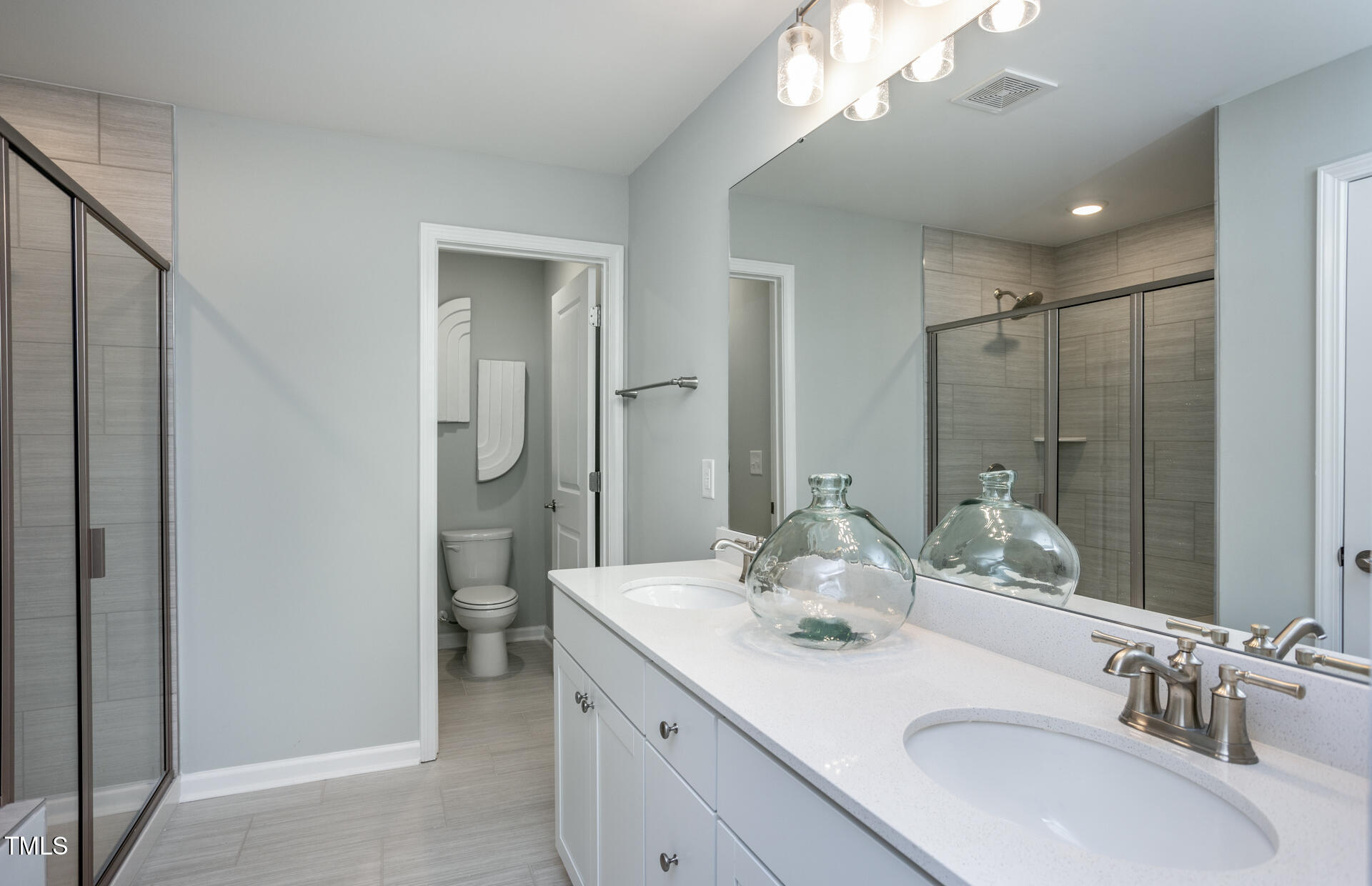 2919 Denson Road Fuquay-Varina, NC 27526 - Photo 11 of 26 a bathroom with a double vanity sink mirror and double