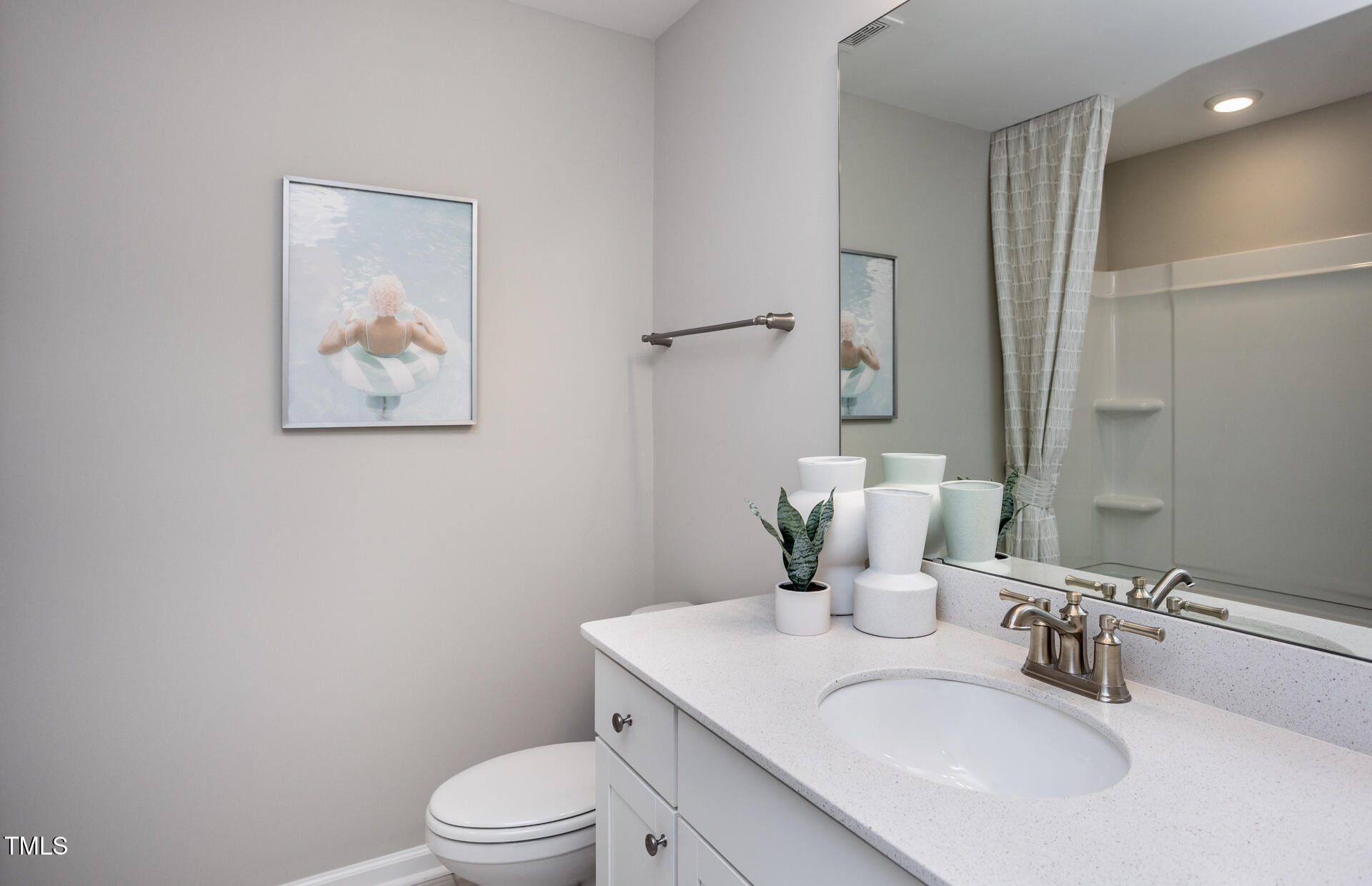 2919 Denson Road Fuquay-Varina, NC 27526 - Photo 16 of 26 a bathroom with a toilet sink and mirror