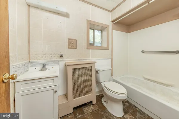 a bathroom with a sink a toilet and a bathtub