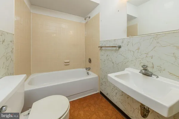 a bathroom with a sink a toilet and bathtub