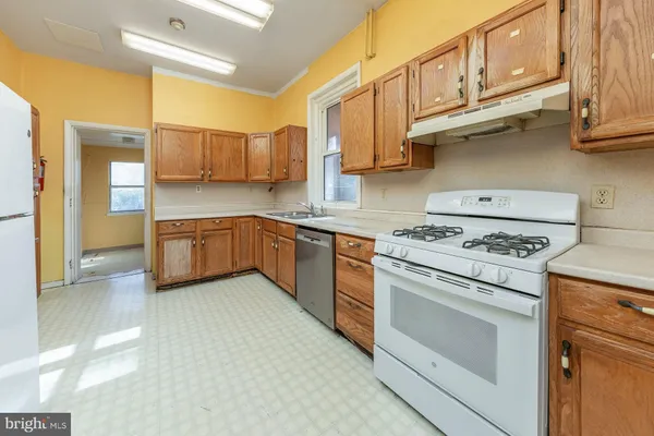 a kitchen with stainless steel appliances granite countertop a stove and a sink