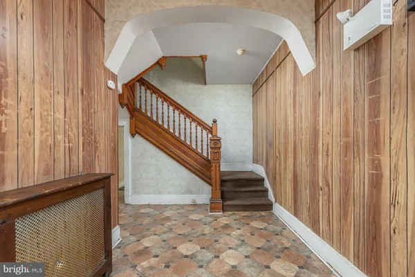 a view of staircase with railing and a window