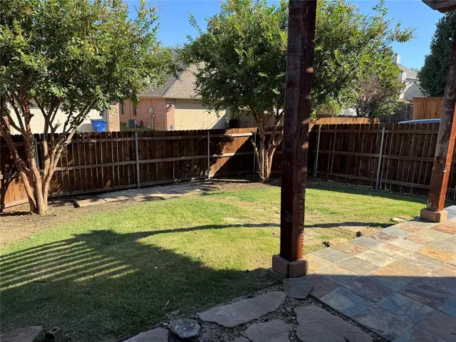 a view of a backyard with a tree