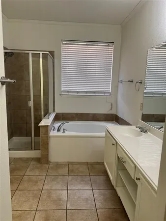 a bathroom with a tub sink and shower