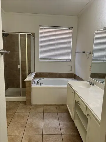 a bathroom with a tub sink and shower