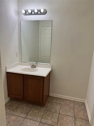 a bathroom with a sink vanity and a mirror