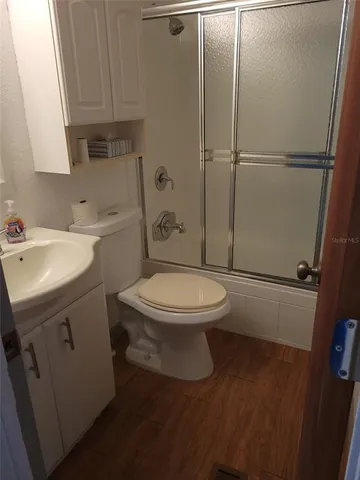 a bathroom with a toilet a sink and shower