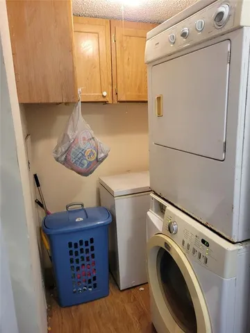 a view of washer and dryer with kitchen in the background