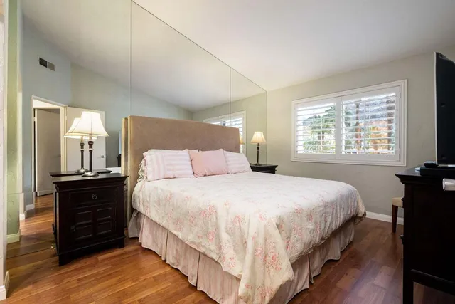 a bedroom with bed and a window