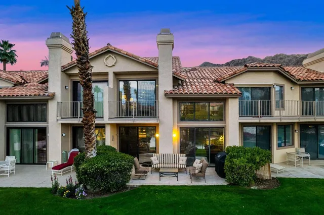 front view of a brick house with a yard