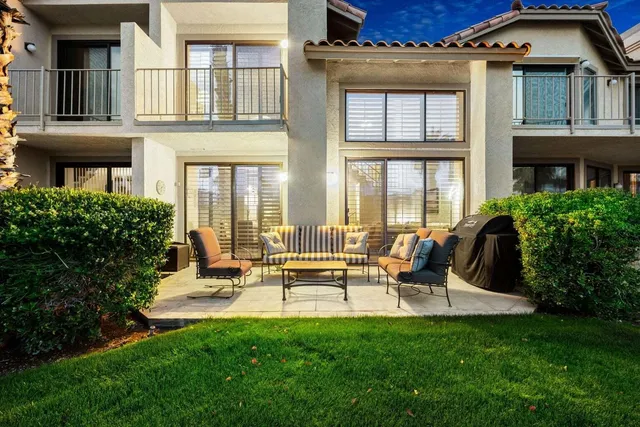 a view of building with outdoor seating and garden