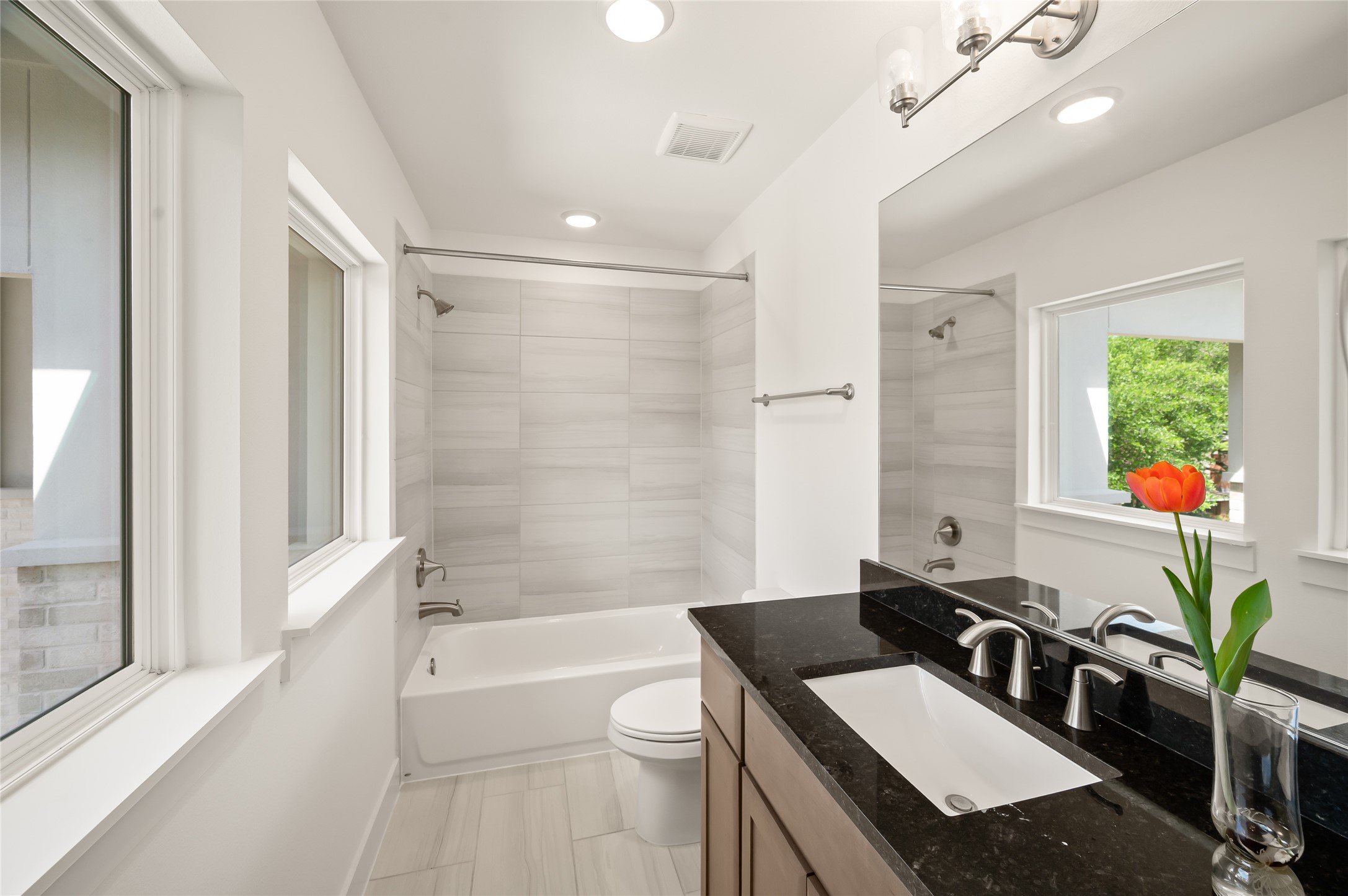 2215 MacArthur Street Houston, TX 77030 - Photo 22 of 33 a bathroom with a sink a toilet a tub and a large mirror