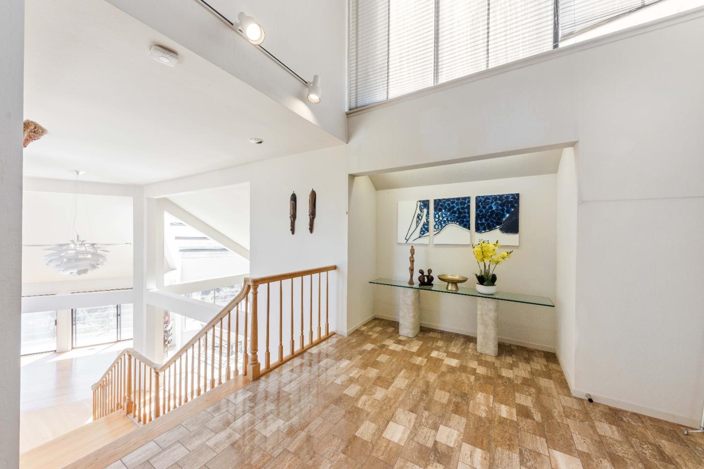 1305 Southdown Road Hillsborough, CA 94010 - Photo 11 of 72 a view of a hallway to room with wooden floor and windows