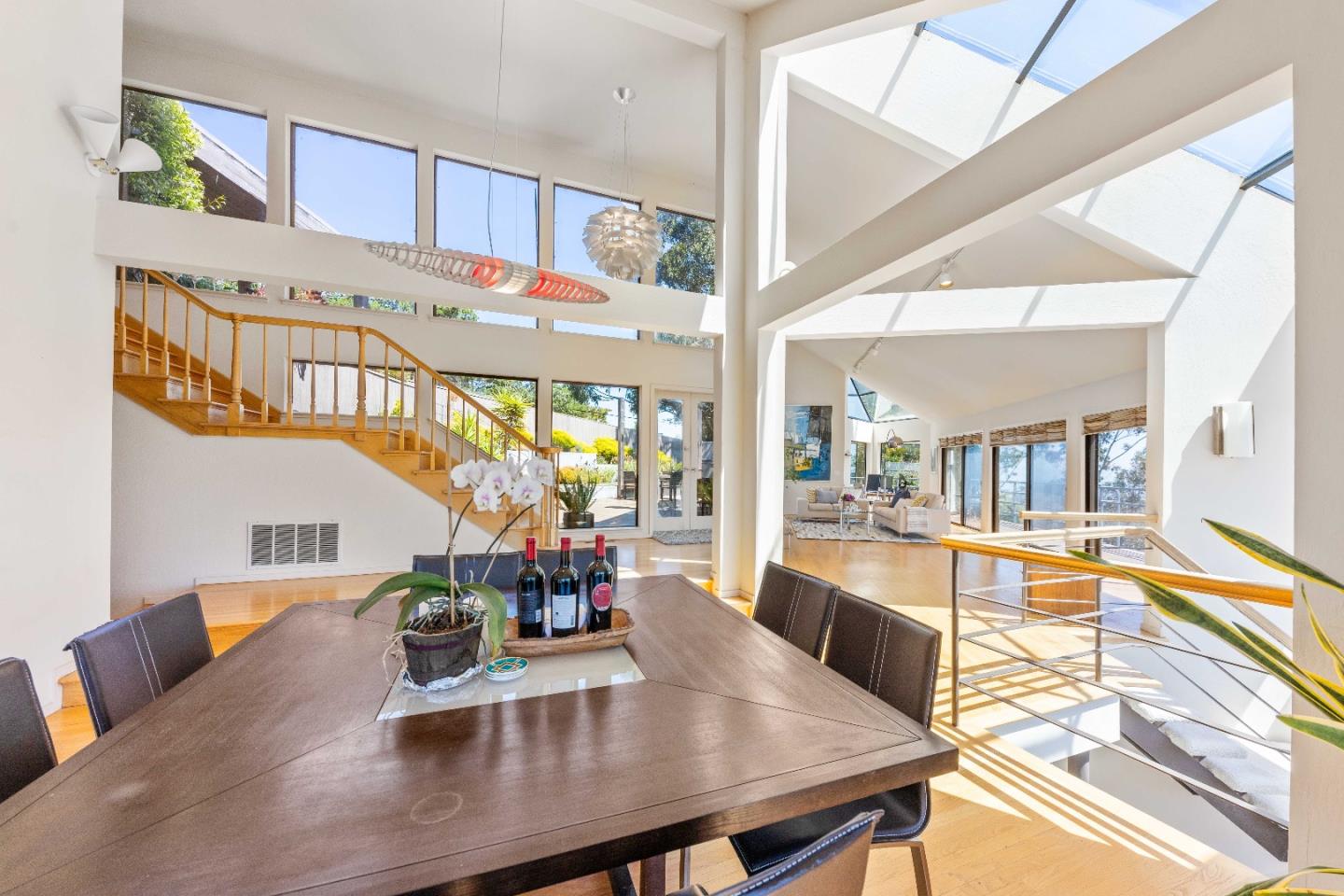 1305 Southdown Road Hillsborough, CA 94010 - Photo 19 of 72 a view of a dining room with furniture a chandelier and wooden floor
