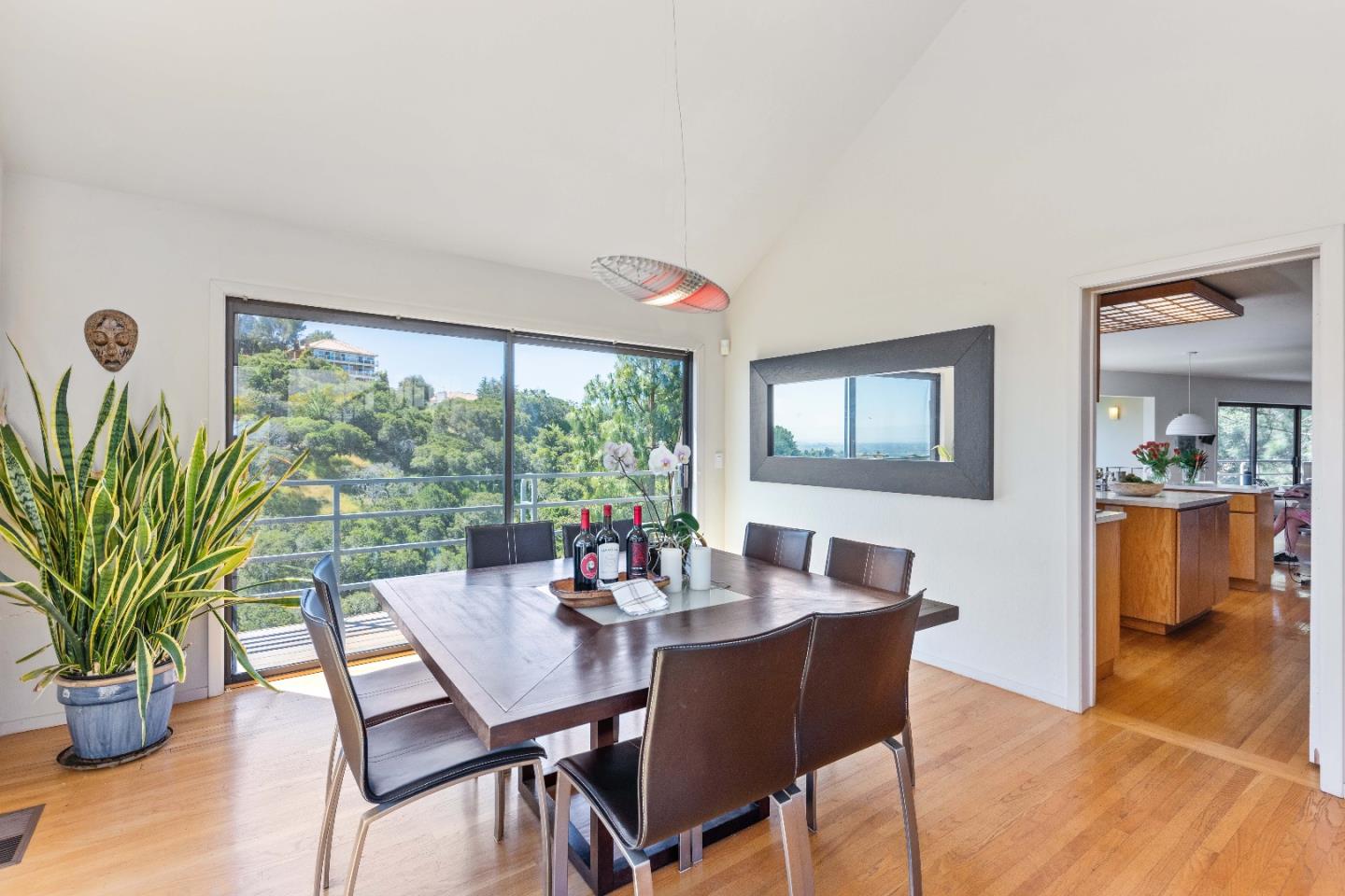 1305 Southdown Road Hillsborough, CA 94010 - Photo 20 of 72 a dining room with furniture potted plants and wooden floor