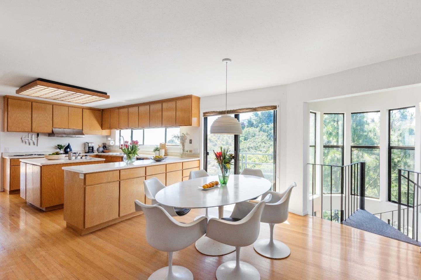 1305 Southdown Road Hillsborough, CA 94010 - Photo 21 of 72 a dining room with furniture a chandelier and wooden floor