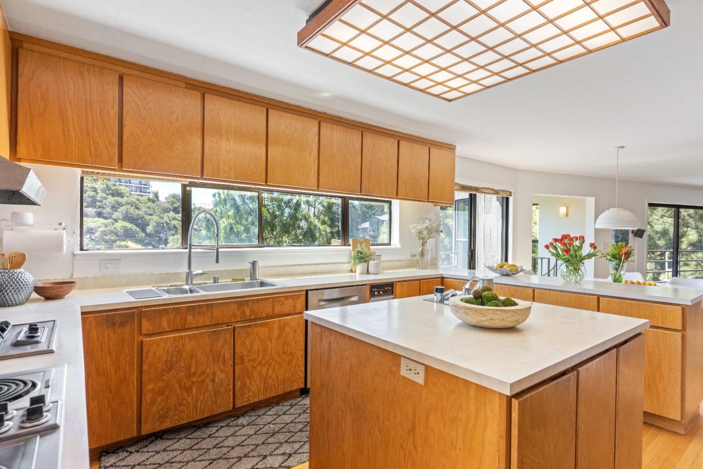 1305 Southdown Road Hillsborough, CA 94010 - Photo 24 of 72 a kitchen with a sink a counter top space and living room filled with furniture