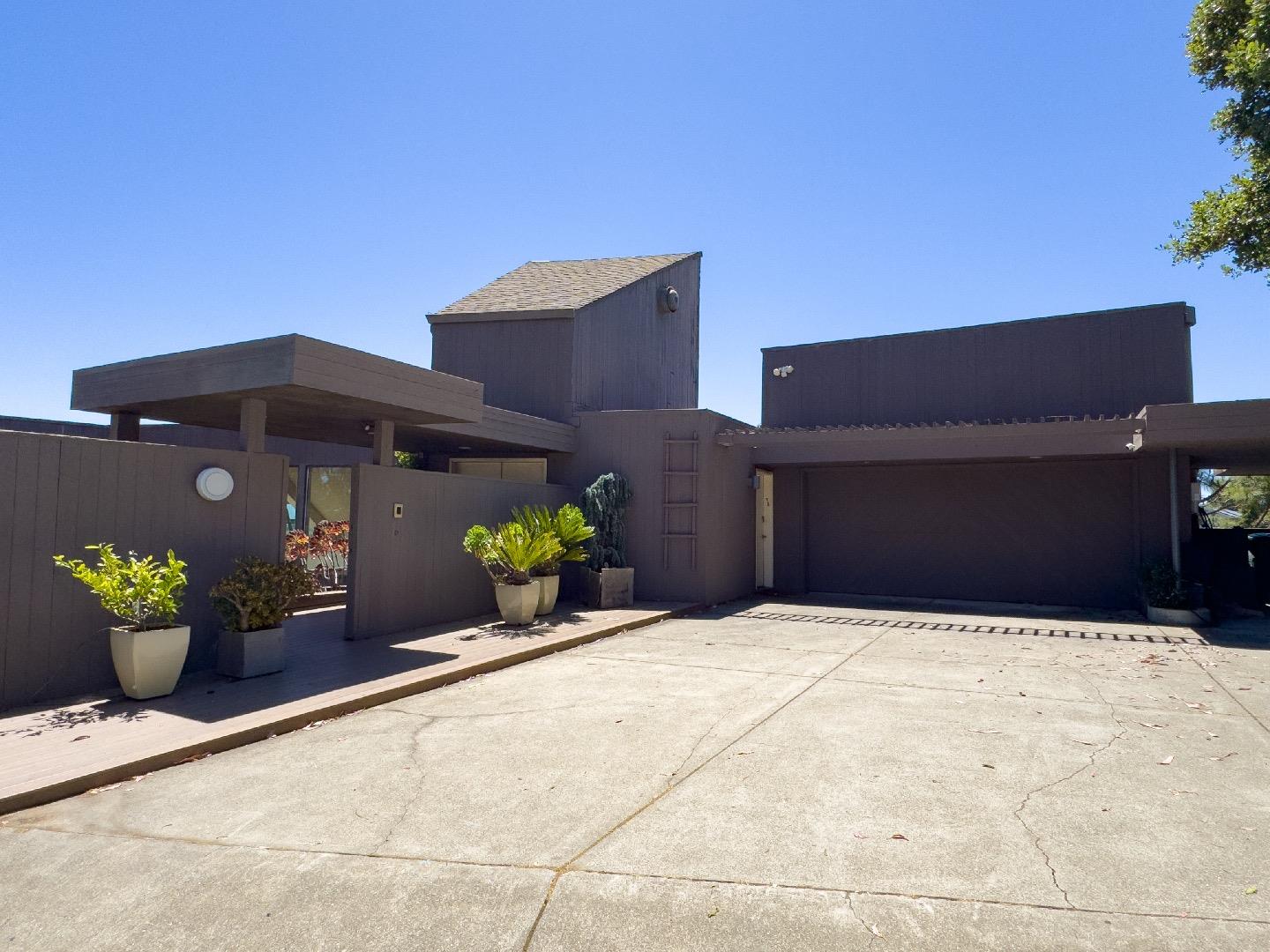 1305 Southdown Road Hillsborough, CA 94010 - Photo 7 of 72 a front view of a house with potted plants