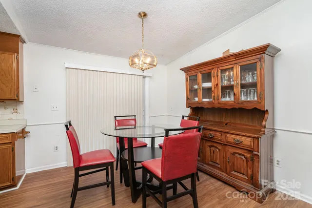 a view of a dining room with furniture wooden floor and a chandelier