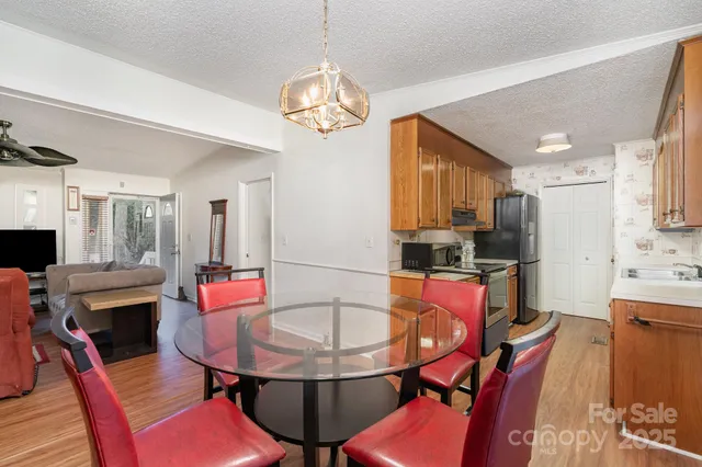 a outdoor dining room with furniture a window and kitchen view