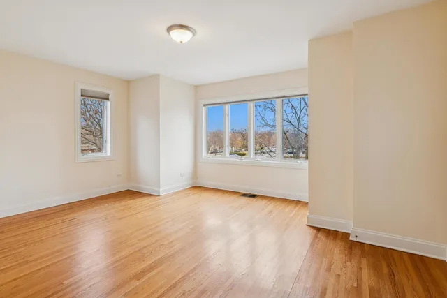 a bathroom with a granite countertop toilet a sink and a mirror