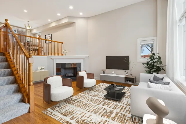 a view of an empty room with wooden floor fireplace and a window