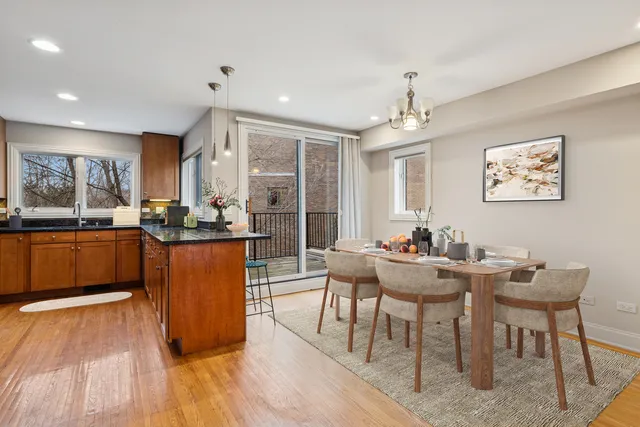 a kitchen with granite countertop a sink cabinets and wooden floor