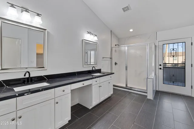 a bathroom with a double vanity sink and mirror