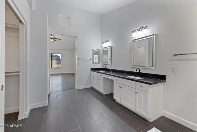 a kitchen with granite countertop a sink and a stove top oven