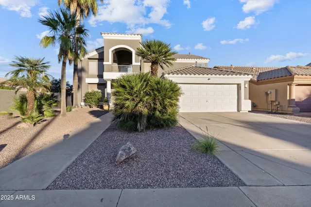 a front view of a house with a yard and a garage