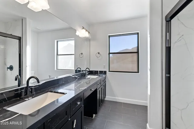 a bathroom with a granite countertop sink a mirror and a