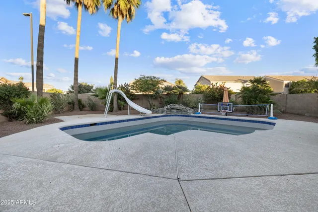 a view of swimming pool with outdoor seating and a pathway