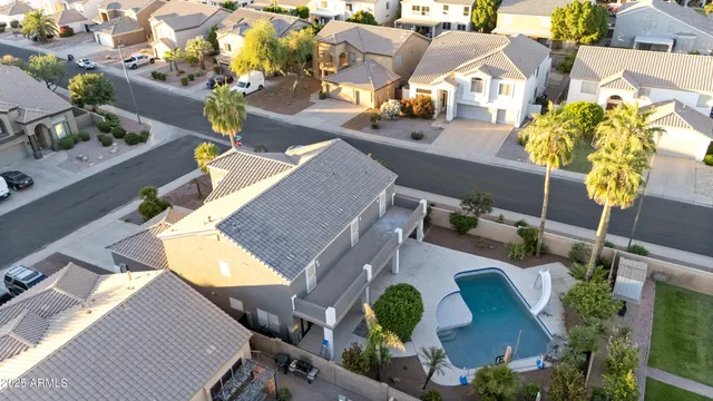 an aerial view of a house with yard swimming pool and outdoor seating