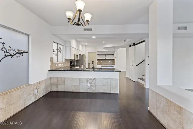 a view of kitchen and center island with wooden floor