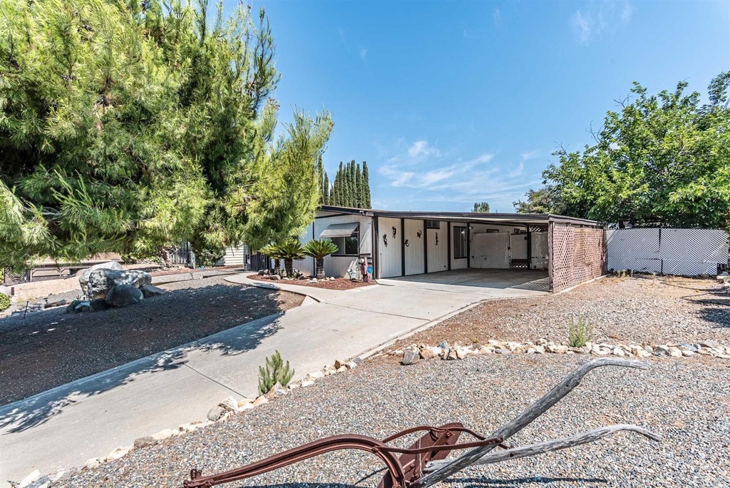 33938 Plowshare Road Wildomar, CA 92595 - Photo 1 of 1 a front view of a house with a yard and garage
