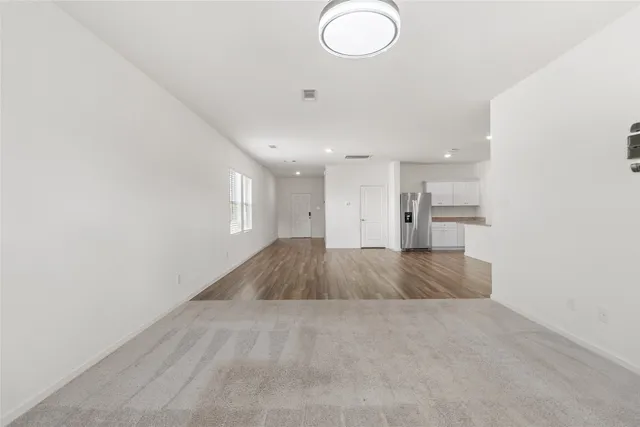 an empty room with a kitchen and a sink