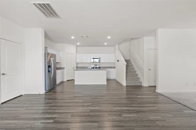 a view of kitchen dining table with cabinets