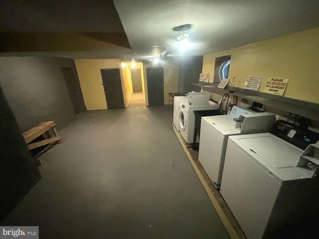 a view of a storage and utility room with washer and dryer