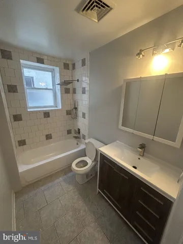 a bathroom with a sink a toilet and bathtub